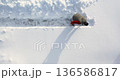 Watch as a man steadily and methodically clears a path through deep snow, exemplifying patience and strength in navigating tough winter terrain. 30 FPS 4k footage. 136586817