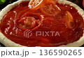 Super Slow Motion of Falling Tomatoes on Pizza Dough . Closeup of Pizza Preparation 136590265
