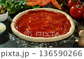 Super Slow Motion of Falling Tomatoes on Pizza Dough . Closeup of Pizza Preparation 136590266