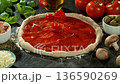 Super Slow Motion of Falling Tomatoes on Pizza Dough . Closeup of Pizza Preparation 136590269