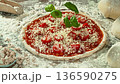 Super Slow Motion of Falling Basil Leaves on Pizza Dough . Closeup of Pizza Preparation 136590275