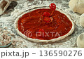 Super Slow Motion of Falling Tomatoes on Pizza Dough . Closeup of Pizza Preparation 136590276