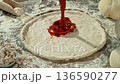 Super Slow Motion of Pouring Tomato Sauce on Pizza Dough . Closeup of Pizza Preparation 136590277