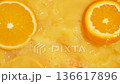 Cinematic splash of juice as orange slices fall from above, top view. 136617896