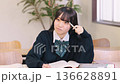 Female high school student/exam taker studying with a serious expression Female high school student/exam taker studying with a serious expression 136628891