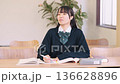 Female high school student/exam taker studying with a serious expression Female high school student/exam taker studying with a serious expression 136628896