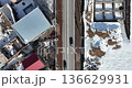 Aerial view of a village in Armenia in winter, with snow-covered roads and cars driving 136629931