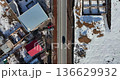 Aerial view of a village in Armenia in winter, with snow-covered roads and cars driving 136629932