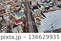Aerial view of a village in Armenia in winter, with snow-covered roads and cars driving 136629935