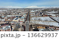 Aerial view of a village in Armenia in winter, with snow-covered roads and cars driving 136629937
