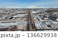 Aerial view of a village in Armenia in winter, with snow-covered roads and cars driving 136629938