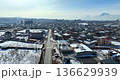 Aerial view of a village in Armenia in winter, with snow-covered roads and cars driving 136629939
