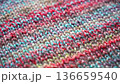 Close-up Texture of Handmade Knitted Clothing with Colorful Yarn Patterns 136659540