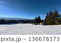 Beautiful POV ski landscape on the mountains. Skier skis down a snowy mountain trail in sunny weather. 136678373