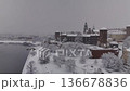 Winter drone circular flight around Wawel Castle from the Vistula River, snow-covered.  136678836