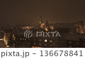 Evening drone view of snowy Wawel Castle with glowing street lights.  136678841