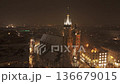 Evening drone flight around snowy St. Marys Church in Krakow.  136679015