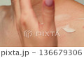 Woman apply cream for hands skin, Close-up of hands with exfoliating cream, demonstrating effective 136679306