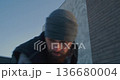 Man Carefully Clears Snowy Path Near Gate 136680004