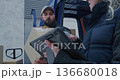 In Cold Snowy Weather, Delivery Crew Loads Parcels Into Van 136680018