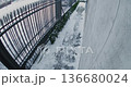 Security Camera Records Man Rushing Down Snow Cleared Sidewalk, Glancing Over Shoulder 136680024