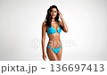 Beautiful woman in blue bikini posing in studio 136697413