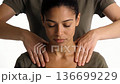 Woman receiving a professional shoulder massage from a therapist. Close-up of relaxed expression 136699229