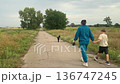Family leisure by walking dog at the meadow 136747245