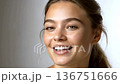 Portrait of a smiling young woman with clean skin on white background 136751666