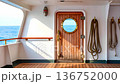 Wooden door with porthole on a luxury yacht or cruise ship deck 136752000