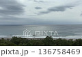 The Pacific Ocean under a cloudy sky, covered with thick clouds, and the Kamogawa beach where waves lapping on the dark sea. 136758469