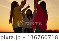 Party, celebration, dancing, group happy people raising hands to sky in evening. People, girls, dancing to music beach party, raising hands in air. Young women having fun outdoors, relaxing in nature 136760718