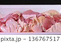 Rotating blocks of chicken thighs on a food tray 136767517