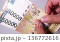 Video of counting Korean banknotes by hand 136772616