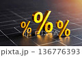 Close up of three golden percent symbols rising on dark grid, warm light, shallow focus 136776393