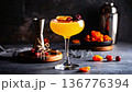 High angle view, ambient light, centered cocktail, dried fruit shadows, diagonal tools, warm cozy mood 136776394
