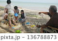 Happy family beach travel vacation summer day child, kid, man enjoy outdoor trip, woman watches, multi generation family playing sand with toys near ocean, man pointing distant view. 136788873