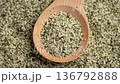 Hemp seeds falling on a wooden spoon in slow motion. Alimentary food supplement. Rotation 136792888
