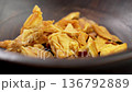 Dried mango chunks in wooden bowl. Sliced dehydrated fruits close up. Healthy snack. Rotation 136792889