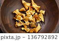 Pile of dried Pineapple chunks. Dehydrated organic yellow fruits in wooden rustic bowl close up. Rotation 136792892