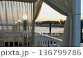 View from beach gazebo, white curtains toward Mediterranean sea at sunset water 136799786
