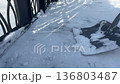 Snow Removal. Methodical Snow Shoveling Creating Small Snow Heaps Under Winter Light 136803487