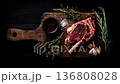 Gourmet Raw Steak With Rosemary and Garlic On Cutting Board 136808028