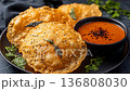 Crispy Indian Papadums with Savory Sauce and Fresh Herbs. 136808030