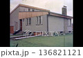 Modern private house exterior in spring. Green, well-kept lawn surrounds house. No people. Contemporary residential architecture with clean landscape. Old film. Archival retro 1970s. Vintage archive 136821121