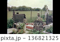 Wide view, European city cemetery in spring. Rows of headstones and tombstones surrounded by green lawn landscape. Peaceful burial ground in urban. Old film. Archival retro 1970s. Vintage archive 136821325
