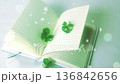 A paperback book and clover sparkling in the spring sunshine 136842656
