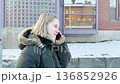 Portrait of a young woman talking by mobile phone on the street  136852926