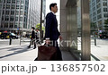 Businessman walking through Tokyo's business district 136857502