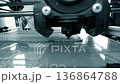 3D printer. 3d printer printing close-up. Molten plastic flowing out of extruder and forming prototype model. New modern additive technologies for printing 3D printer. Electronic device for modeling. 136864788